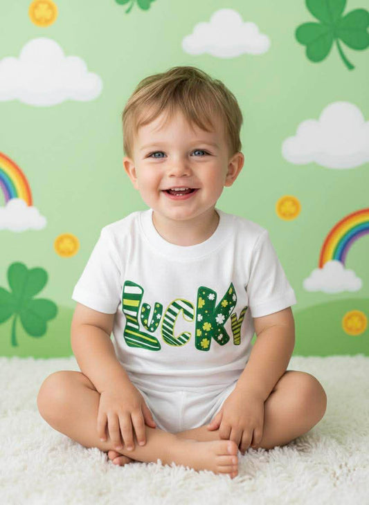 Child wearing a 'Lucky' shirt with a St. Patrick's Day-themed background